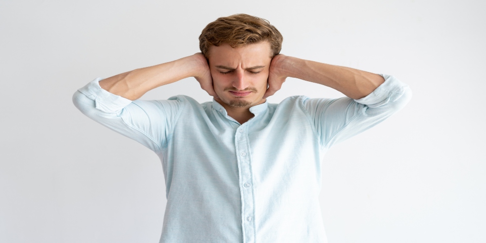 A man covering his ears depicting ignorance