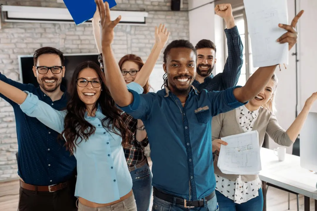 A group of happy employees celebrating, depicting the joy of good internal customer service