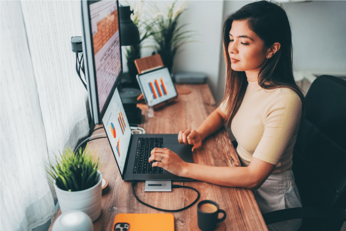A virtual customer service representative sitting on her desk working.